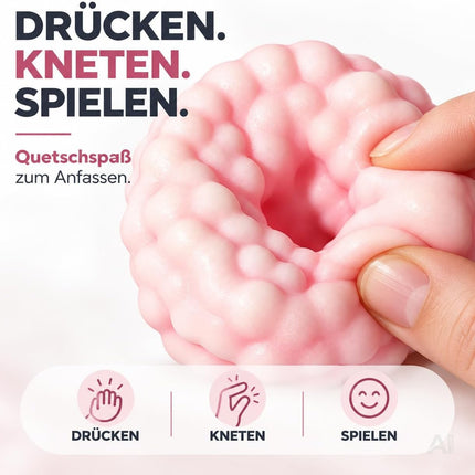 Pinker Squishy wird mit den Händen zusammengedrückt